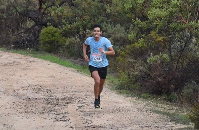 A PaceOn athlete racing on a bush trail
